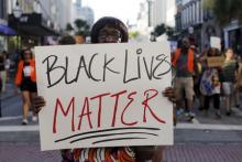 Louise Brown walks in the "March for Black Lives" after passing by the Emanuel African Methodist Episcopal Church in Charleston, South Carolina June 20, 2015 three days after a mass shooting left nine dead during a bible study at the church. PHOTO BY REUTERS/Brian Snyder