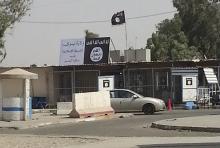 A sign (in white) by the Islamic State is seen in the city of Mosul