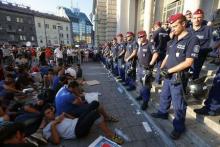 Migrants form a sit-down demonstration as police block the entrance to the main Eastern Railway station in Budapest, Hungary, September 1, 2015. PHOTO BY REUTERS/Laszlo Balogh