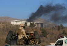 Afghan security forces keep watch as smoke rises from the Intercontinental Hotel in Kabul, Afghanistan, January 21, 2018. PHOTO BY REUTERS/Omar Sobhani