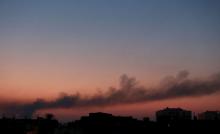 Black smoke billows in the sky above areas where clashes are taking place between pro-government forces, who are backed by the locals, and the Benghazi Revolutionaries Shura Council, an alliance of former anti-Gaddafi rebels, in Benghazi, Libya September 1, 2015. PHOTO BY REUTERS/Esam Omran Al-Fetori