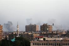 Smoke rises from Yarmouk Palestinian camp in Damascus, Syria, April 19, 2018. PHOTO BY REUTERS/Ali Hashisho