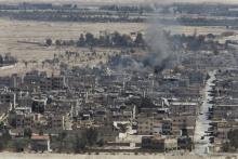Smoke rises from the modern city of Palmyra, in Homs Governorate, Syria April 1, 2016. PHOTO BY REUTERS/Omar Sanadiki