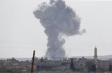 Smoke rises after an U.S.-led air strike in the Syrian town of Kobani