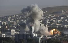 Smoke rises after an U.S.-led air strike in the Syrian town of Kobani