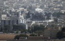 Smoke rises from the Syrian town of Kobani, seen from near the Mursitpinar border crossing on the Turkish-Syrian border in the southeastern town of Suruc in Sanliurfa province 