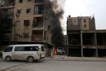 Smoke rises from a car after strikes on the rebel-held besieged al-Zebdieh district, in Aleppo Syria, December 5, 2016. PHOTO BY REUTERS/Abdalrhman Ismail