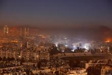 Smoke and flames rise after air strikes on rebel-controlled besieged area of Aleppo, as seen from a government-held side, in Syria, December 11, 2016. PHOTO BY REUTERS/Omar Sanadiki