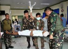 A soldier lays on a stretcher and is carried by his comrades inside the Camp Bautista hospital after sustaining wounds in a gunfight with Islamic State-linked Abu Sayyaf militants in Talipao town, Sulu province, Philippines. PHOTO BY REUTERS/Nickee Butlangan