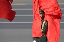 A soldier from honour guards holds a red flag during a welcoming ceremony held for Vietnam's President Tran Dai Quang outside the Great Hall of the People, in Beijing, China, May 11, 2017. PHOTO BY REUTERS/Jason Lee