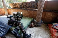 A Filipino soldier lies on a mattress at their combat position in a house as government troops continue their assault against insurgents from the Maute group in Marawi city, Philippines, July 1, 2017. PHOTO BY REUTERS/Jorge Silva