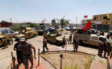 Iraqi security forces gather with Shi'ite fighters in the town of Garma, Iraq, May 26, 2016. PHOTO BY REUTERS/Thaier Al-Sudani