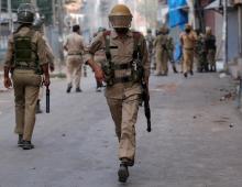 A policeman runs during a protest in Srinagar against the recent killings in Kashmir, July 18, 2016. PHOTO BY REUTERS/Danish Ismail