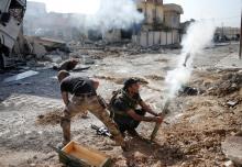 Iraqi special forces soldiers fire a mortar round at Islamic State fighters positions in Tahrir neighborhood of Mosul, Iraq. PHOTO BY REUTERS/Goran Tomasevic