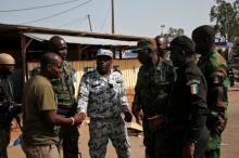 Mutinying soldiers shake hands with Ivory Coast's National Police officer as they prepare to leave the checkpoint at the entrance to Bouake, Ivory Coast, May 16, 2017. PHOTO BY REUTERS/Luc Gnago