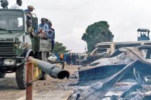 Security personnel sitting on a truck watch burned vehicles at the front gate of the Makala prison after it was attacked by supporters of jailed Christian sect leader Ne Muanda Nsemi in Kinshasa, Democratic Republic of the Congo, May 17, 2017. PHOTO BY REUTERS/Robert Carrubba