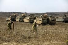 Israeli soldiers demarcate an area as they stand near armoured personnel carriers (APCs) during an exercise in the Israeli-occupied Golan Heights, near the ceasefire line between Israel and Syria, August 21, 2015. PHOTO BY REUTERS/Baz Ratner