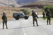 Israeli soldiers stand guard near the scene where two Palestinian men were shot dead by Israeli troops at a checkpoint in the West Bank, January 9, 2016. PHOTO BY REUTERS/Abed Omar Qusini