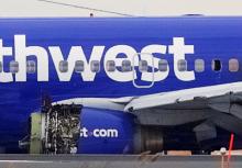 Emergency personnel monitor the damaged engine of Southwest Airlines Flight 1380, which diverted to the Philadelphia International Airport this morning after the airline crew reported damage to one of the aircraft's engines, on a runway in Philadelphia, Pennsylvania U.S., April 17, 2018. PHOTO BY REUTERS/Mark Makela