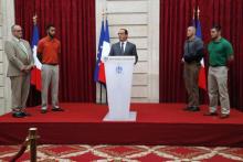 French President Francois Hollande (C) delivers a speech as British businessman Chris Norman (L), U.S. student Anthony Sadler (2ndL), U.S. Airman First Class Spencer Stone (2ndR) and U.S. National Guardsman Alek Skarlatos (R) listen to during a ceremony at the Elysee Palace in Paris, France, August 24, 2015. PHOTO BY REUTERS/Michel Euler