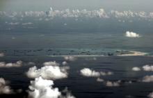 An aerial photo taken through a glass window of a Philippine military plane shows the alleged on-going land reclamation by China on mischief reef in the Spratly Islands in the South China Sea, west of Palawan, Philippines, May 11, 2015. PHOTO BY REUTERS/Ritchie B. Tongo