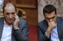 Greek Prime Minister Alexis Tsipras (R) and Economy Minister George Stathakis attend a parliamentary session in Athens, Greece, August 14, 2015. PHOTO BY REUTERS/Christian Hartmann