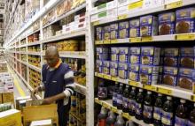A worker arranges goods at a Makro branch of South African retailer Massmart in Johannesburg, May 31, 2011. PHOTO BY REUTERS/Siphiwe Sibeko