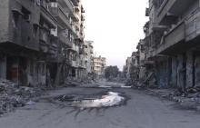 A general view shows a deserted street filled with debris of damaged buildings in Deir al-Zor March 5, 2014. PHOTO BY REUTERS/Stringer