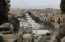 A general view shows damaged buildings along a deserted street and an area controlled by forces loyal to Syria's President Bashar Al-Assad, as seen from a rebel-controlled area at the Bab al-Nasr frontline in Aleppo, February 10, 2015. PHOTO BY REUTERS/Hosam Katan