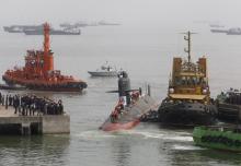 Indian Navy's Scorpene submarine INS Kalvari is escorted by tugboats as it arrives at Mazagon Docks Ltd, a naval vessel ship building yard, in Mumbai, India, October 29, 2015. PHOTO BY REUTERS/Shailesh Andrade