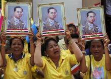 Well-wishers hold up pictures of Thailand's King Bhumibol Adulyadej at Siriraj Hospital in Bangkok, Thailand, May 10, 2015. PHOTO BY REUTERS/Chaiwat Subprasom
