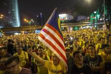 Supporters of pro-democracy group "Bersih" (Clean) sing the national anthem during a rally near Dataran Merdeka in Malaysia's capital city of Kuala Lumpur, Malaysia, August 30, 2015. PHOTO BY REUTERS/Athit Perawongmetha