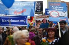 Supporters of the right-wing Alternative for Germany (AfD) demonstrate against the German government's new policy for migrants in Berlin, Germany, November 7, 2015. The text reads 'Merkel must go'. PHOTO BY REUTERS/Hannibal Hanschke