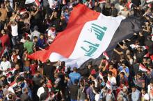 Supporters of prominent Iraqi Shi'ite cleric Moqtada al-Sadr display a huge Iraqi flag during a protest against government corruption at Tahrir Square in Baghdad, Iraq March 11, 2016. PHOTO BY REUTERS/Ahmed Saad