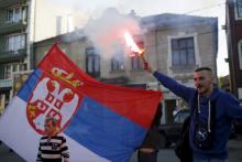A supporter of Radical Party leader Vojislav Seselj lights a flare before Seselj's pre-election rally in Jagodina, Serbia, April 12, 2016. PHOTO BY REUTERS/Marko Djurica