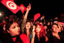 Supporters of the Nidaa Tounes (Call for Tunisia) secular party movement wave flags and shout slogans in Tunis, December 21, 2014. PHOTO BY REUTERS/Anis Mili