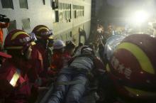 The 19-year-old survivor (C) is carried on a stretcher after being pulled out by rescuers more than 60 hours after a landslide hit an industrial park on Sunday, in Shenzhen, Guangdong province, China, December 23, 2015. PHOTO BY REUTERS/China Daily