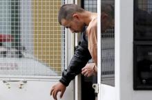 Suspect of last year's Bangkok blast Bilal Mohammed (also known as Adem Karadag) is escorted by prison officers as he arrives at the military court in Bangkok, Thailand, February 16, 2016. PHOTO BY REUTERS/Chaiwat Subprasom