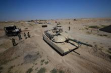 A tank of Iraqi army members and Shi'ite Popular Mobilization Forces (PMF) are seen in Al-Al-Fateha military airport south of Hawija, Iraq, October 2, 2017. PHOTO BY REUTERS/Stringer