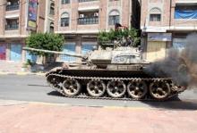 A pro-government fighter rides on a tank during clashes with Houthi fighters in Yemen's southwestern city of Taiz, October 22, 2015. PHOTO BY REUTERS/Stringer