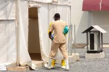 A health worker enters a tent in an Ebola virus treatment center in Conakry, Guinea, November 17, 2015. PHOTO BY REUTERS/Saliou Samb