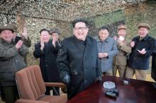 North Korean leader Kim Jong Un (C) smiles as he guides a test fire of a new multiple launch rocket system in this undated photo released by North Korea's Korean Central News Agency (KCNA) in Pyongyang March 4, 2016. PHOTO BY REUTERS