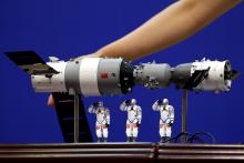 A model of the Tiangong-1 space lab module (L), the Shenzhou-9 manned spacecraft (R) and three Chinese astronauts is displayed during a news conference at Jiuquan Satellite Launch Center, in Gansu province, China, June 15, 2012. PHOTO BY REUTERS/Jason Lee