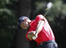 Tiger Woods of the U.S. hits off the third tee in the final round of the Tour Championship golf tournament at East Lake Golf Club in Atlanta