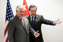US Secretary of State Rex Tillerson (L) and China's Foreign Minister Wang Yi take their seats before a meeting on the sidelines of a gathering of Foreign Ministers of the G20 leading and developing economies at the World Conference Center in Bonn, western Germany, February 17, 2017. PHOTO BY REUTERS/Brendan Smialowski