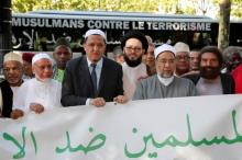 French-Jewish writer Marek Halter (R), Imam Hassen Chalghoumi (3d L) and other Imams, are seen during the start of a European tour to the sites of recent Islamist attacks, to remember the victims and condemn violence, in Champs-Elysees, Paris, France, July 8, 2017. PHOTO BY REUTERS/Pascal Rossignol