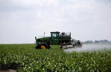 A worker uses a John Deere tractor to spray a field of crops during a crop-eating armyworm invasion at a farm in Settlers, northern province of Limpopo, South Africa, February 8, 2017. PHOTO BY REUTERS/Siphiwe Sibeko