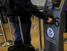 A traveler has his passport scanned as he passes through U.S. Customs and Immigration after using the Cross Border Xpress pedestrian bridge between San Diego and the Tijuana airport on the facility's opening day in Otay Mesa, California, December 9, 2015. PHOTO BY REUTERS/Mike Blake