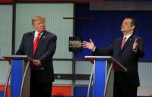Republican U.S. presidential candidate businessman Donald Trump (L) listens as rival candidate Senator Ted Cruz speaks during the Fox Business Network Republican presidential candidates debate in North Charleston, South Carolina, January 14, 2016. PHOTO BY REUTERS/Chris Keane
