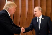 U.S. President Donald Trump and Russia's President Vladimir Putin shake hands during the G20 Summit in Hamburg, Germany in this still image taken from video, July 7, 2017. PHOTO BY REUTERS/Steffen Kugler/Courtesy of Bundesregierung